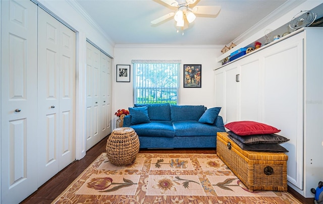 living area with ceiling fan, light hardwood / wood-style flooring, and ornamental molding