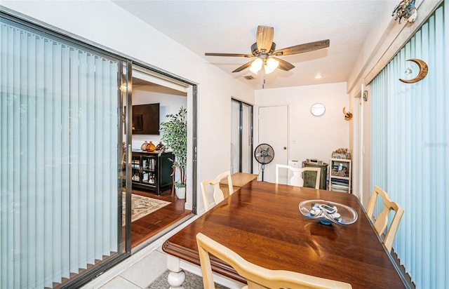 dining space with ceiling fan and hardwood / wood-style flooring