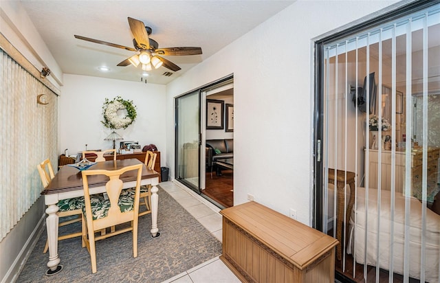 tiled dining room featuring ceiling fan