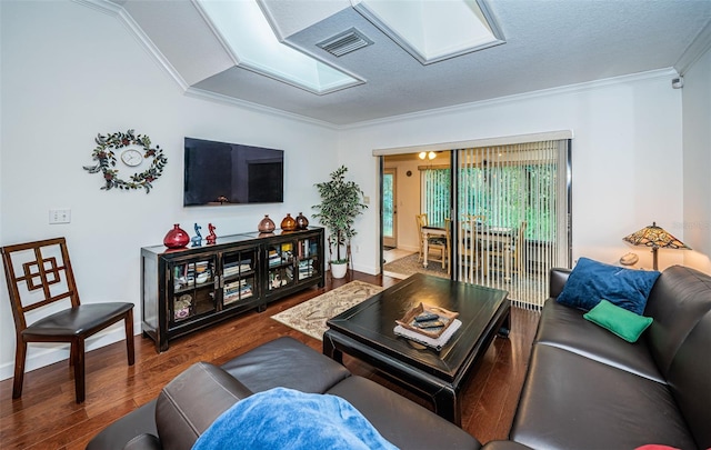 living room with crown molding, hardwood / wood-style floors, and a skylight