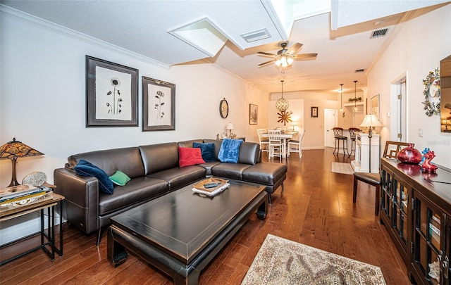 living room with dark hardwood / wood-style flooring, ornamental molding, and ceiling fan