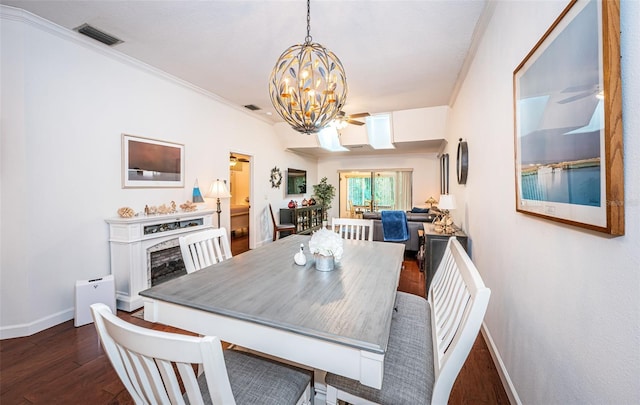 dining area featuring ceiling fan with notable chandelier, ornamental molding, and hardwood / wood-style flooring