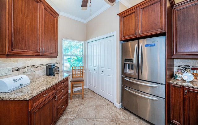 kitchen featuring backsplash, stainless steel refrigerator with ice dispenser, light stone counters, light tile patterned floors, and ceiling fan