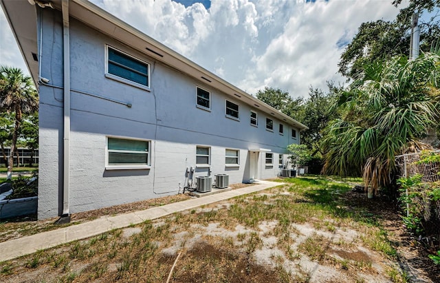 rear view of property featuring central AC