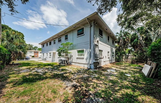 rear view of property with a lawn