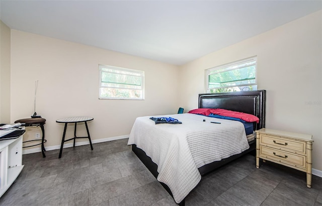 tiled bedroom with multiple windows