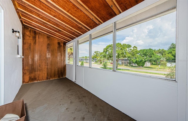 unfurnished sunroom featuring lofted ceiling