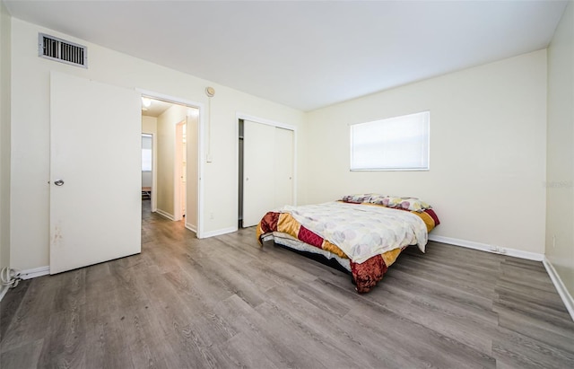 bedroom with a closet and hardwood / wood-style floors