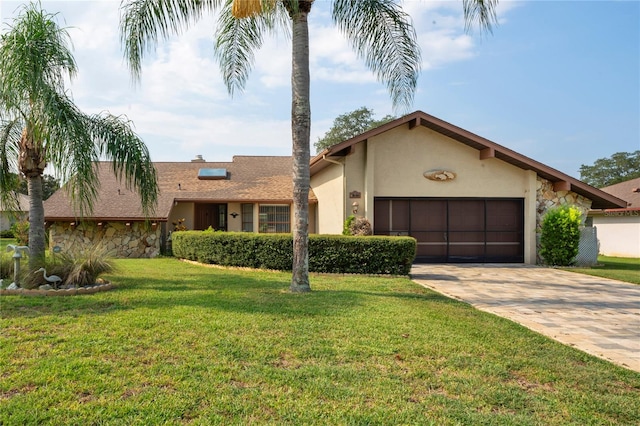 view of front of home with a front yard and a garage