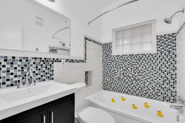 full bathroom featuring vanity, backsplash, tile walls, toilet, and tiled shower / bath