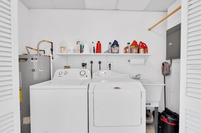 laundry area with water heater, washer and clothes dryer, and tile patterned flooring