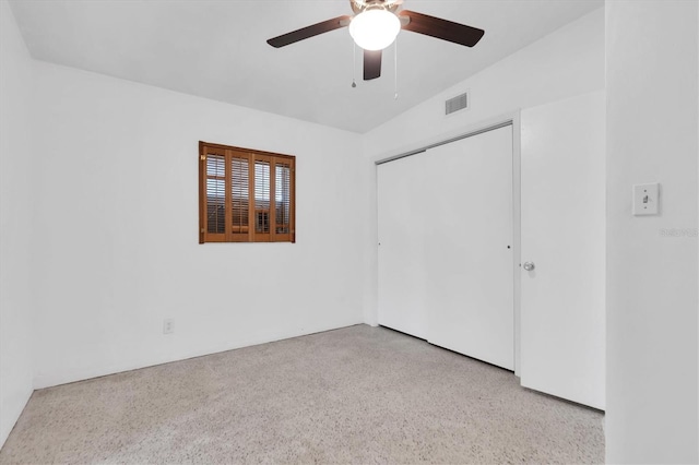 unfurnished bedroom with vaulted ceiling, ceiling fan, and a closet