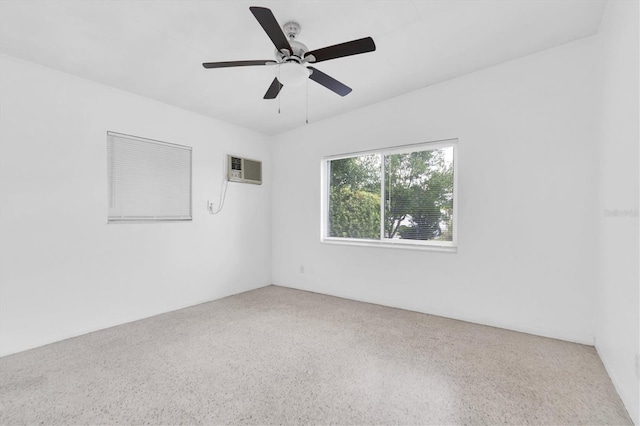 empty room with a wall mounted AC, ceiling fan, and carpet