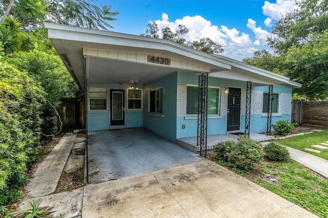 view of front facade with a porch and a carport