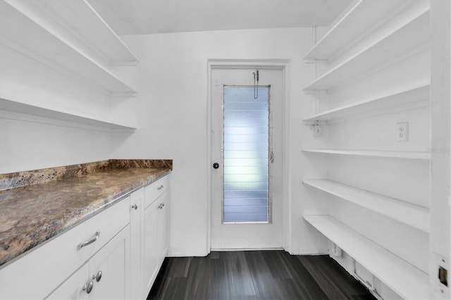 kitchen featuring stone counters, dark hardwood / wood-style floors, and white cabinetry