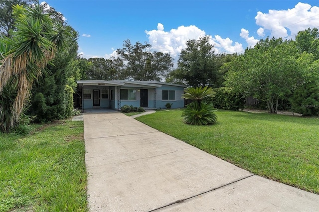 ranch-style home with a front yard and a carport