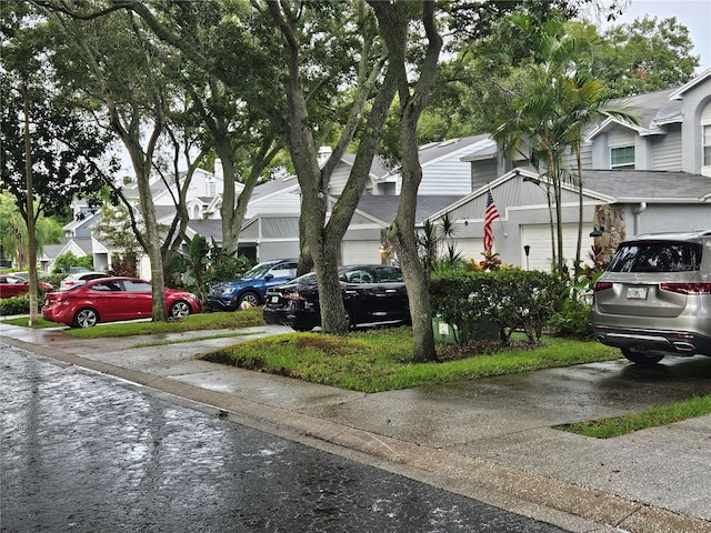 view of parking / parking lot featuring a garage