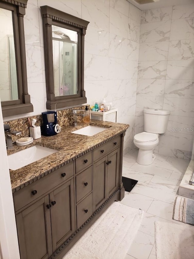 bathroom with tile patterned flooring, tile walls, toilet, and dual vanity