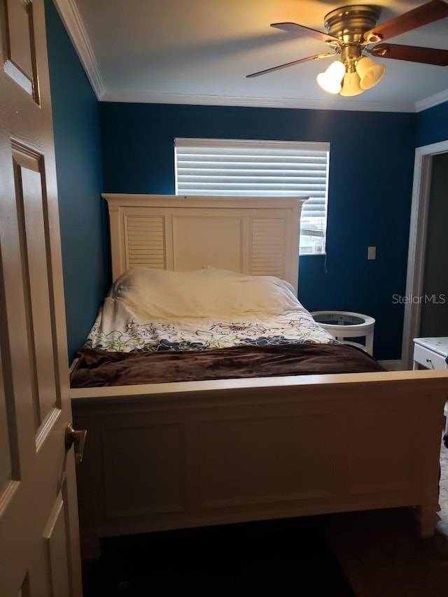 bedroom with ceiling fan and ornamental molding