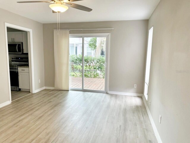 empty room featuring ceiling fan and light hardwood / wood-style flooring