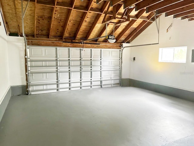 garage featuring electric panel and a garage door opener