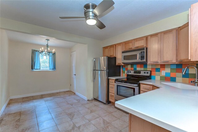 kitchen featuring sink, decorative backsplash, ceiling fan with notable chandelier, light tile patterned floors, and stainless steel appliances