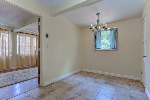 tiled spare room with beam ceiling, a notable chandelier, and plenty of natural light