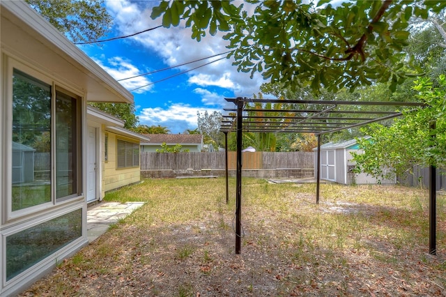 view of yard with a storage unit and a pergola