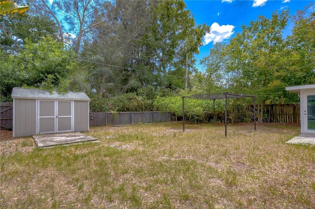 view of yard with a storage shed and a pergola