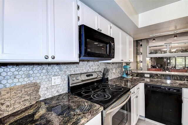 kitchen with dark stone countertops, tasteful backsplash, track lighting, white cabinetry, and black appliances