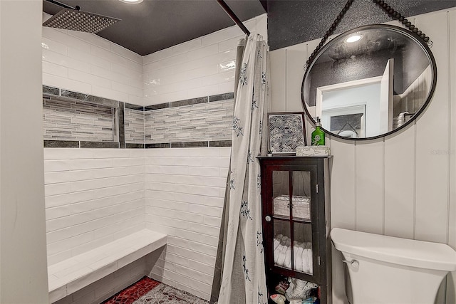 bathroom featuring toilet and walk in shower