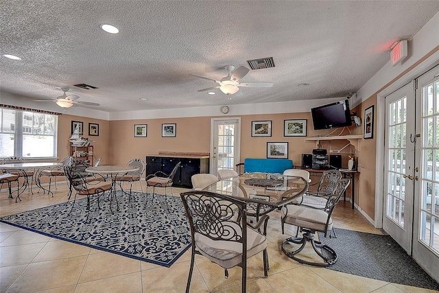 living room with a wealth of natural light, french doors, and ceiling fan