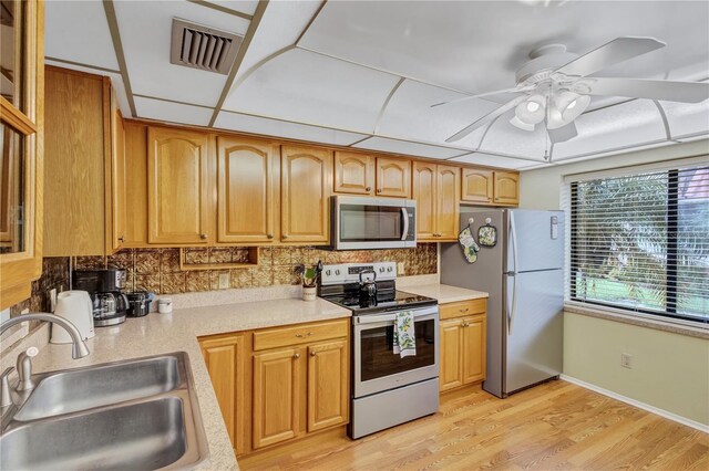 19029 US Highway 19 N Unit 12B, Clearwater, FL 33764 - kitchen featuring appliances with stainless steel finishes, a sink, light countertops, and ceiling fan