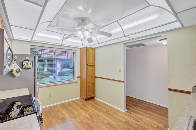 19029 US Highway 19 N Unit 12B, Clearwater, FL 33764 - kitchen with appliances with stainless steel finishes, ceiling fan, light wood-type flooring, light countertops, and baseboards