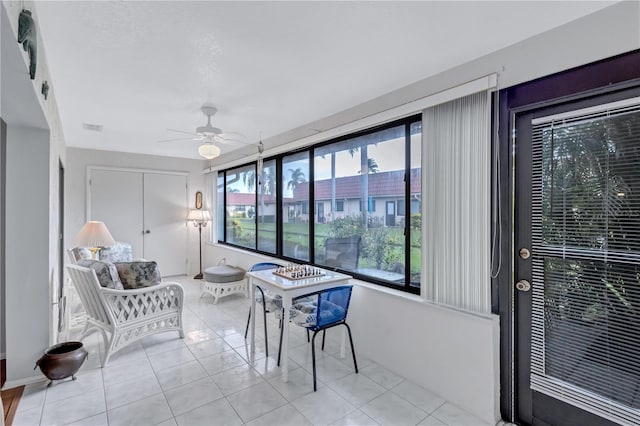 sunroom / solarium featuring ceiling fan