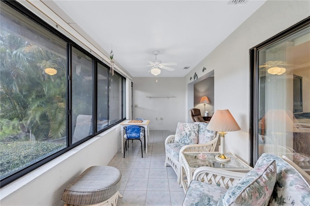 sunroom featuring ceiling fan