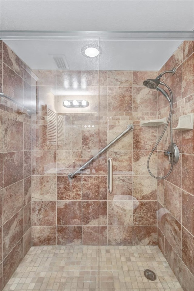 bathroom with a shower with door