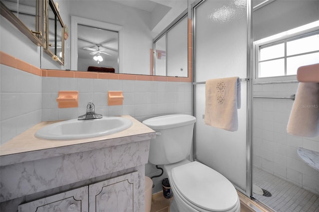 bathroom featuring toilet, a shower stall, and vanity