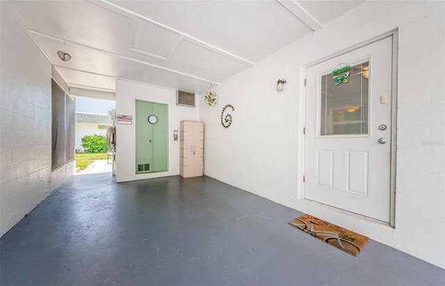 interior space featuring visible vents and concrete block wall