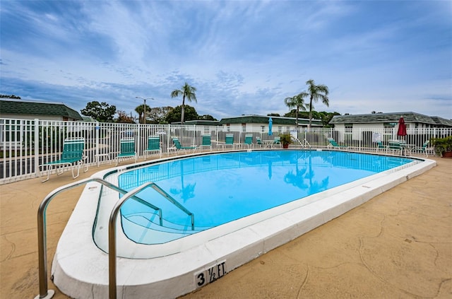 pool featuring a patio and fence