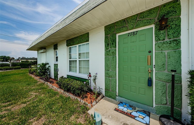 property entrance with a yard