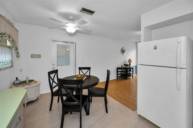 dining area featuring visible vents, ceiling fan, baseboards, and light tile patterned floors