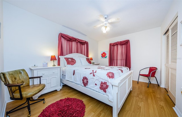 bedroom featuring baseboards, a closet, a ceiling fan, and light wood-style floors