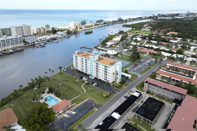 birds eye view of property with a water view and a city view