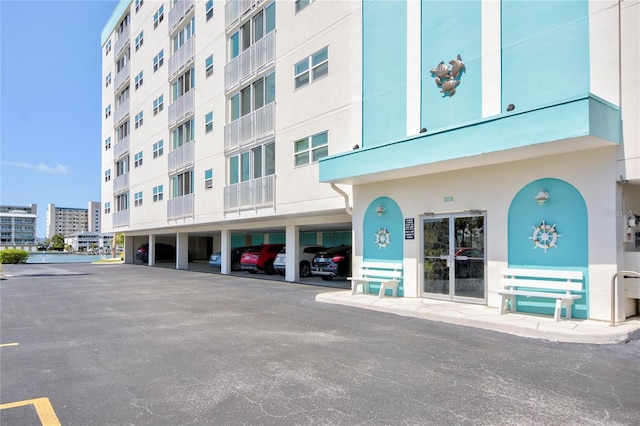 view of building exterior with covered parking