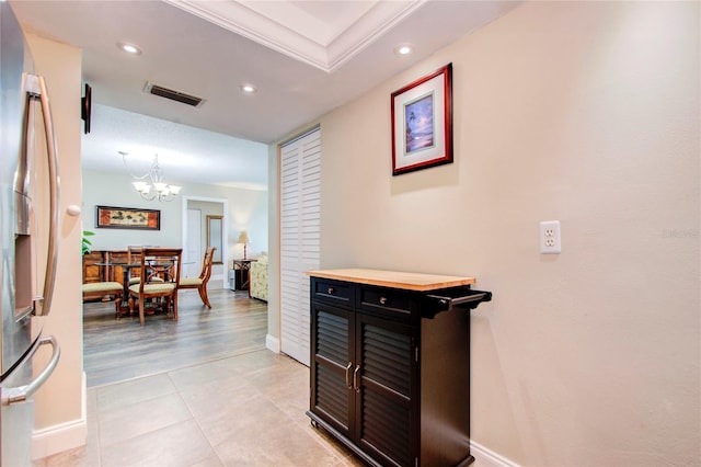 hallway with recessed lighting, visible vents, baseboards, and light tile patterned floors