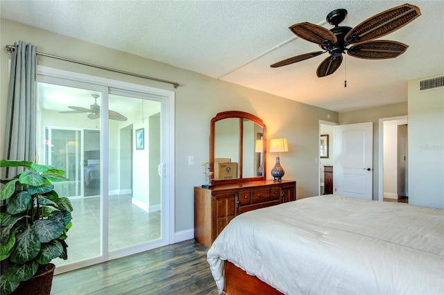 bedroom featuring a textured ceiling, access to outside, wood-type flooring, and ceiling fan