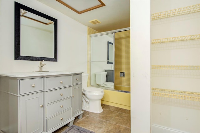 full bathroom featuring vanity, toilet, tile patterned floors, and bath / shower combo with glass door