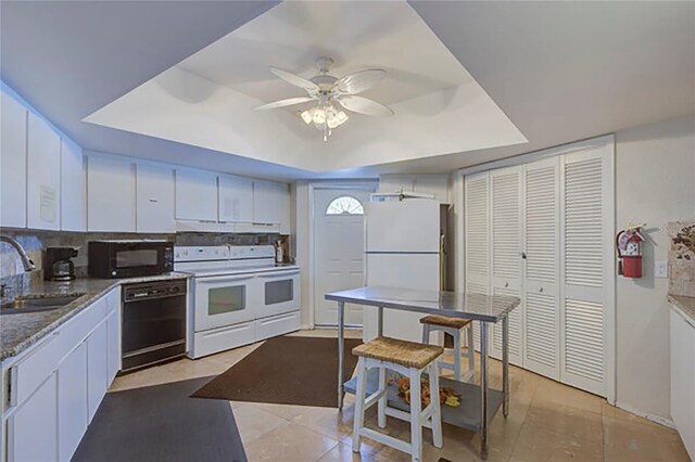 kitchen with black appliances, white cabinetry, sink, and ceiling fan