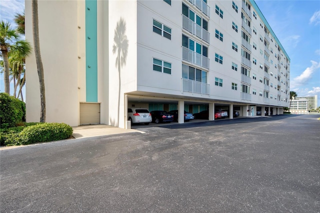 view of building exterior with covered parking